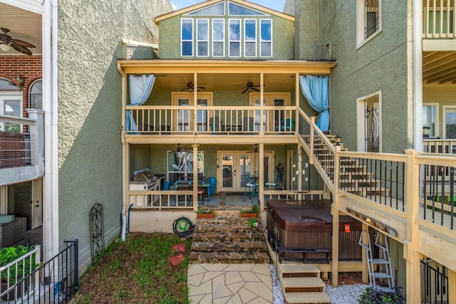 145 Capetown, Montgomery, TX 77356 - back of property featuring french doors, stucco siding, ceiling fan, a hot tub, and stairs