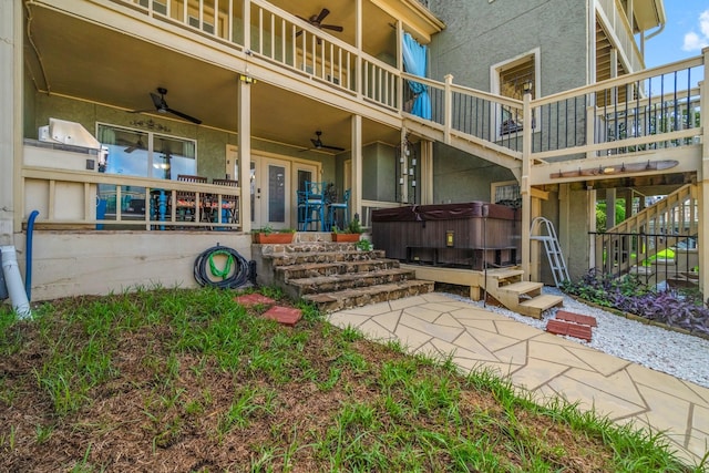 145 Capetown, Montgomery, TX 77356 - doorway to property with a hot tub, a ceiling fan, and stucco siding