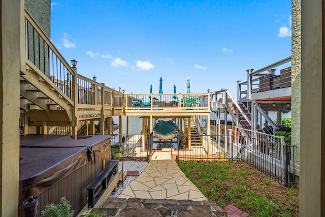 145 Capetown, Montgomery, TX 77356 - view of yard featuring stairs, a hot tub, a patio area, and a deck