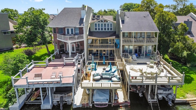 145 Capetown, Montgomery, TX 77356 - rear view of house with boat lift, a balcony, and a patio