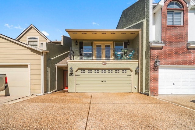 145 Capetown, Montgomery, TX 77356 - view of front facade featuring a balcony, concrete driveway, and an attached garage