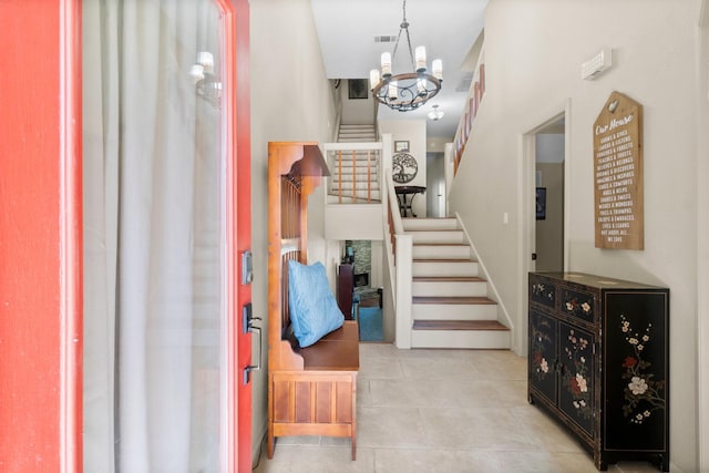 145 Capetown, Montgomery, TX 77356 - foyer with stairway, tile patterned floors, and a chandelier