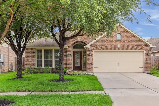 3112 Rock Brook Falls Ln, League City, TX 77573 - view of front of property featuring brick siding, a garage, driveway, and a front yard