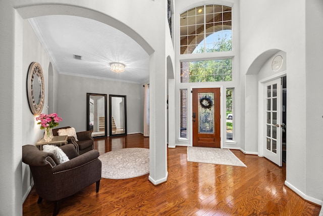 4402 Eden Point Ln, Katy, TX 77494 - foyer entrance featuring arched walkways, wood finished floors, crown molding, and a high ceiling