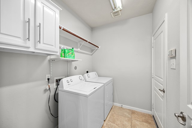 4402 Eden Point Ln, Katy, TX 77494 - laundry area featuring cabinet space, washing machine and clothes dryer, and light tile patterned floors