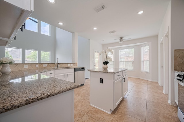 4142 Regal Stone Ln, Sugar Land, TX 77479 - kitchen featuring dishwasher, light stone countertops, decorative backsplash, white cabinets, and light tile patterned flooring