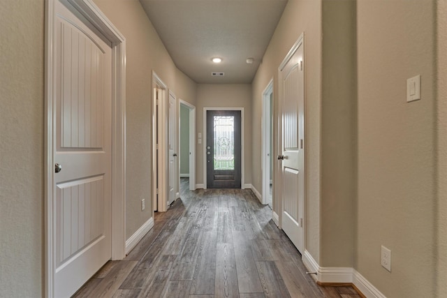 10477 Valley Dr N, Willis, TX 77318 - doorway with dark wood-style flooring and baseboards