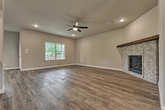 10477 Valley Dr N, Willis, TX 77318 - unfurnished living room featuring ceiling fan, wood finished floors, a brick fireplace, and recessed lighting