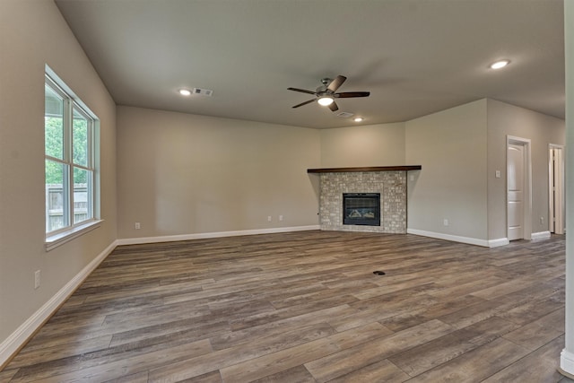 10477 Valley Dr N, Willis, TX 77318 - unfurnished living room featuring dark wood-style flooring, ceiling fan, recessed lighting, and a fireplace