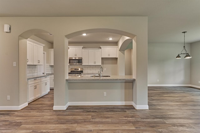 10477 Valley Dr N, Willis, TX 77318 - kitchen with stainless steel appliances, dark wood finished floors, and tasteful backsplash
