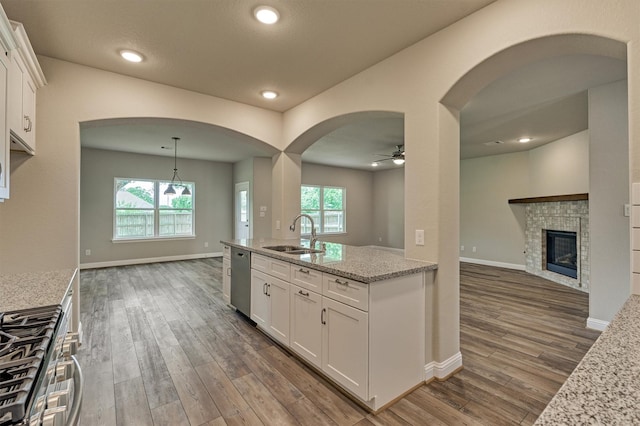 10477 Valley Dr N, Willis, TX 77318 - kitchen featuring open floor plan, stainless steel appliances, dark wood-type flooring, a ceiling fan, and white cabinetry