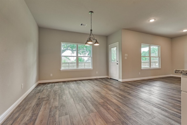 10477 Valley Dr N, Willis, TX 77318 - empty room with healthy amount of natural light, dark wood finished floors, and recessed lighting