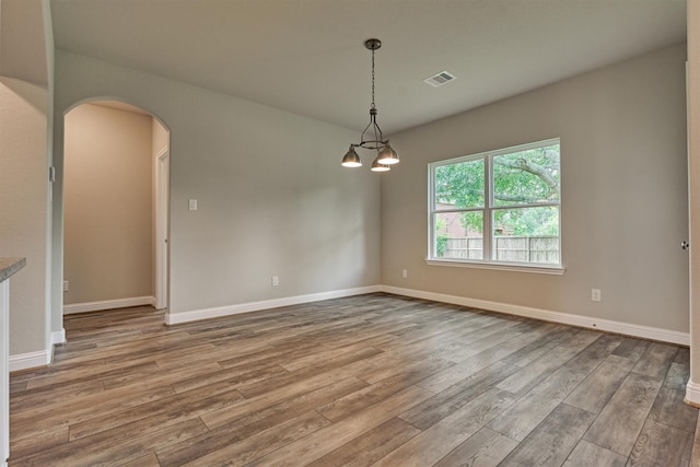 10477 Valley Dr N, Willis, TX 77318 - unfurnished room featuring wood finished floors and arched walkways