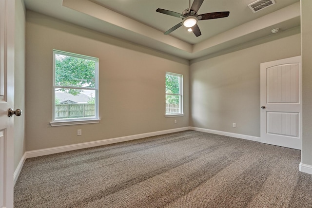 10477 Valley Dr N, Willis, TX 77318 - unfurnished room featuring a raised ceiling, carpet flooring, ceiling fan, and a smoke detector