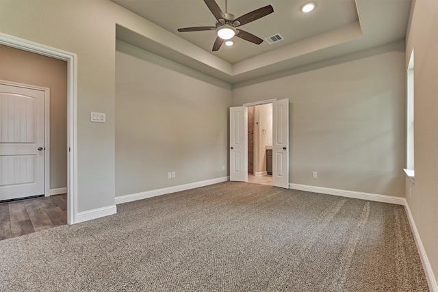 10477 Valley Dr N, Willis, TX 77318 - unfurnished bedroom with carpet floors, a raised ceiling, recessed lighting, and ensuite bath
