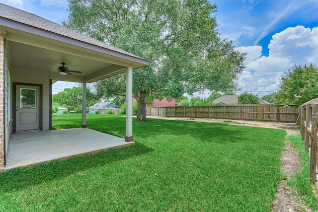 10477 Valley Dr N, Willis, TX 77318 - fenced backyard with a ceiling fan and a patio area