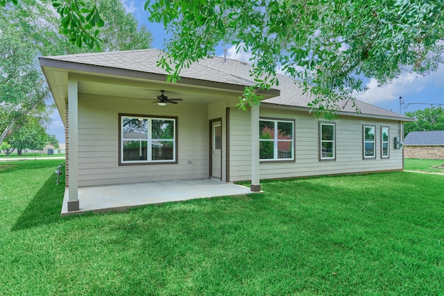10477 Valley Dr N, Willis, TX 77318 - rear view of property with ceiling fan, a lawn, a patio, and a shingled roof