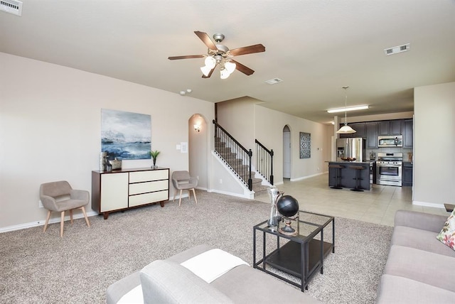 3514 Marquesa Ln, Houston, TX 77084 - living area featuring arched walkways, stairway, and ceiling fan