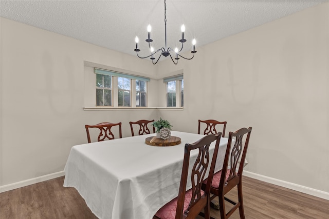 2006 Echo Ridge Ct, Houston, TX 77339 - dining room featuring a chandelier, wood finished floors, and a textured ceiling