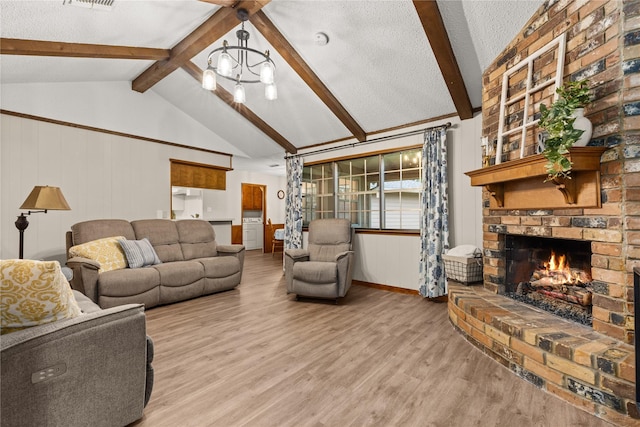 2006 Echo Ridge Ct, Houston, TX 77339 - living area with a chandelier, wood finished floors, a brick fireplace, and a textured ceiling