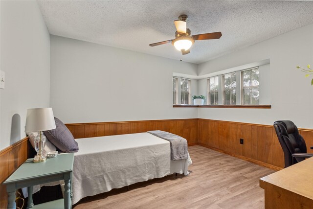 2006 Echo Ridge Ct, Houston, TX 77339 - bedroom featuring a wainscoted wall, an office area, wood finished floors, a textured ceiling, and wooden walls