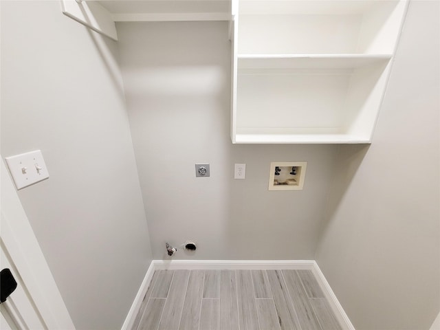 18106 Water Mill Dr, Cypress, TX 77429 - laundry area with hookup for a washing machine, hookup for an electric dryer, wood finish floors, and hookup for a gas dryer
