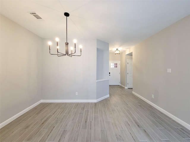 18106 Water Mill Dr, Cypress, TX 77429 - unfurnished room featuring a chandelier and light wood-style floors