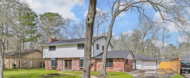 1201 Shady Oak Ln, Dickinson, TX 77539 - view of front of home featuring brick siding, a garage, driveway, a chimney, and a shingled roof