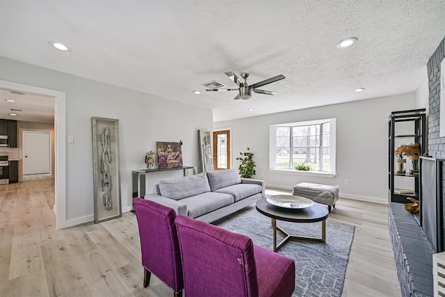 1201 Shady Oak Ln, Dickinson, TX 77539 - living area with a ceiling fan, light wood-style flooring, recessed lighting, and a textured ceiling