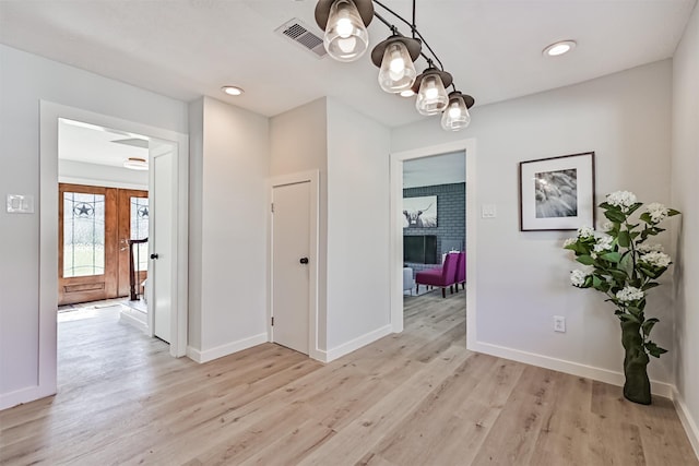 1201 Shady Oak Ln, Dickinson, TX 77539 - hallway featuring light wood-type flooring, a chandelier, and recessed lighting