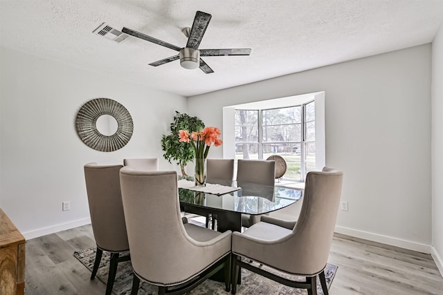 1201 Shady Oak Ln, Dickinson, TX 77539 - dining room featuring wood finished floors, ceiling fan, and a textured ceiling