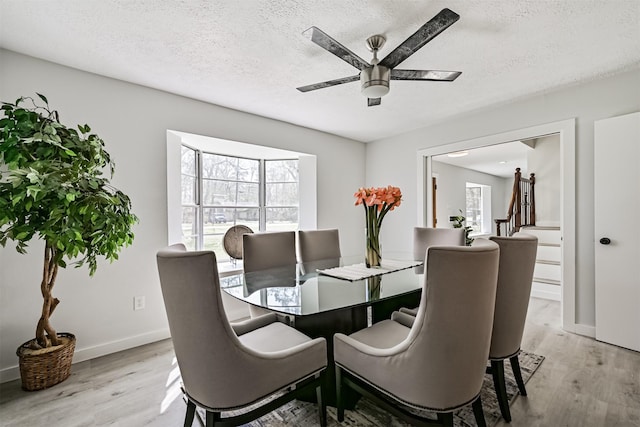 1201 Shady Oak Ln, Dickinson, TX 77539 - dining room with light wood-style flooring, a ceiling fan, and a textured ceiling