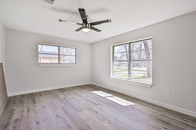 1201 Shady Oak Ln, Dickinson, TX 77539 - unfurnished room with wood finished floors, a ceiling fan, and a textured ceiling