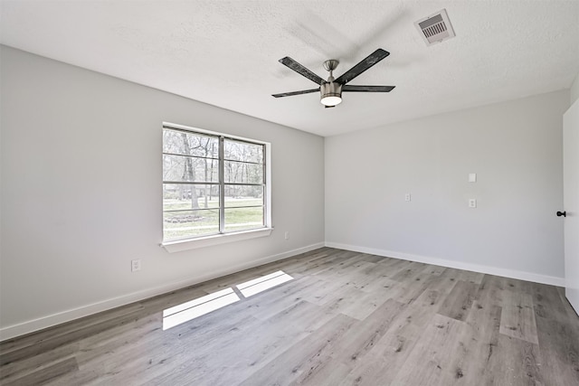 1201 Shady Oak Ln, Dickinson, TX 77539 - empty room with a ceiling fan, wood finished floors, and a textured ceiling
