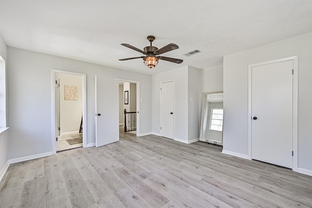 1201 Shady Oak Ln, Dickinson, TX 77539 - unfurnished bedroom with light wood-type flooring, connected bathroom, and ceiling fan