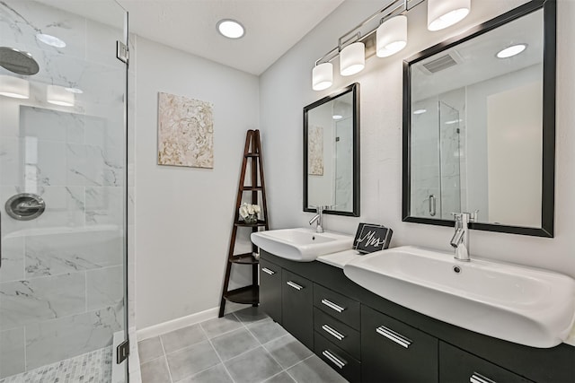 1201 Shady Oak Ln, Dickinson, TX 77539 - bathroom featuring a marble finish shower, double vanity, and tile patterned floors