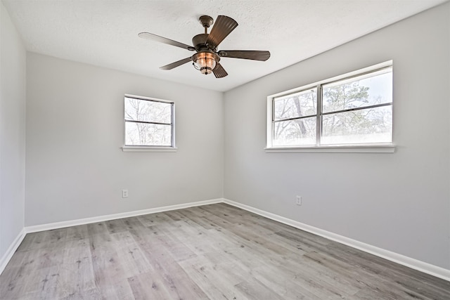 1201 Shady Oak Ln, Dickinson, TX 77539 - empty room with plenty of natural light, wood finished floors, and ceiling fan