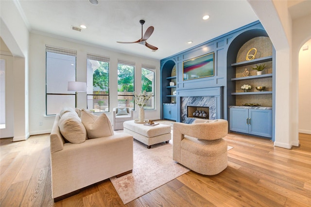 1403 Wakefield Dr, Houston, TX 77018 - living room featuring crown molding, a high end fireplace, light wood-type flooring, ceiling fan, and recessed lighting