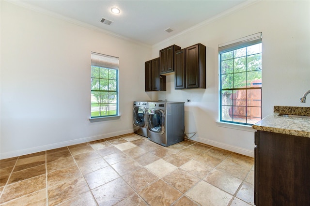 1403 Wakefield Dr, Houston, TX 77018 - washroom with cabinet space, washer and clothes dryer, ornamental molding, and light stone finish flooring