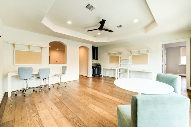 1403 Wakefield Dr, Houston, TX 77018 - living area featuring a tray ceiling, ceiling fan, light wood-style flooring, and recessed lighting