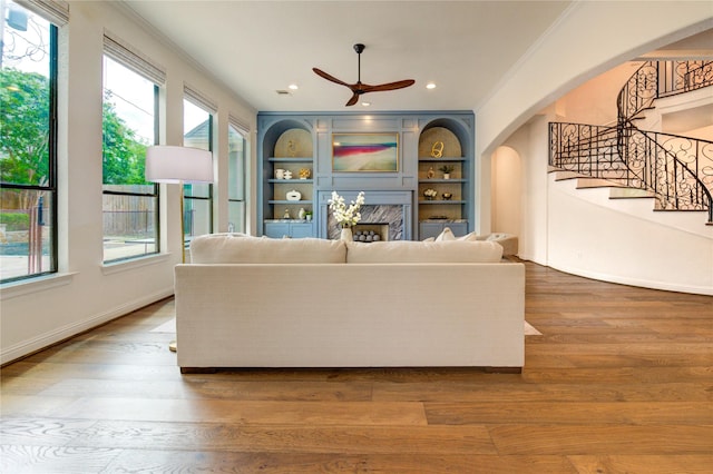 1403 Wakefield Dr, Houston, TX 77018 - living room with arched walkways, ceiling fan, crown molding, stairway, and plenty of natural light