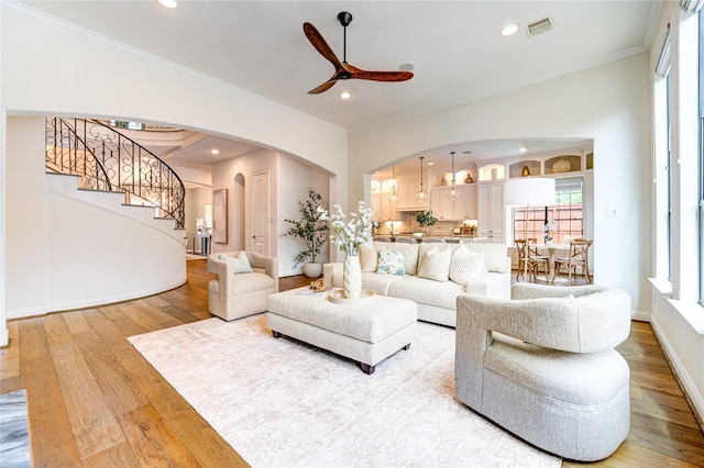 1403 Wakefield Dr, Houston, TX 77018 - living room with arched walkways, ornamental molding, a ceiling fan, wood finished floors, and stairway