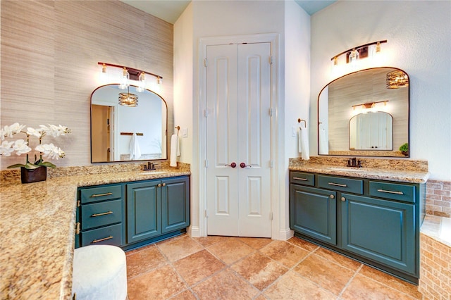 1403 Wakefield Dr, Houston, TX 77018 - full bath featuring two vanities, tiled tub, and stone tile floors