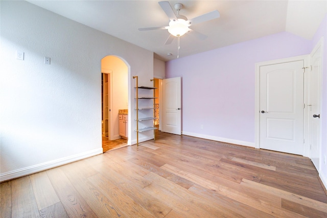 1403 Wakefield Dr, Houston, TX 77018 - unfurnished bedroom with arched walkways, light wood-style floors, ensuite bathroom, and a ceiling fan