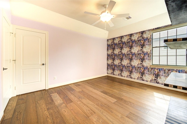 1403 Wakefield Dr, Houston, TX 77018 - empty room featuring wood finished floors, a ceiling fan, and wallpapered walls