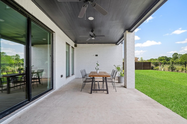 6618 Mirabeau Ln, Katy, TX 77493 - fenced backyard with a ceiling fan, outdoor dining space, and a patio