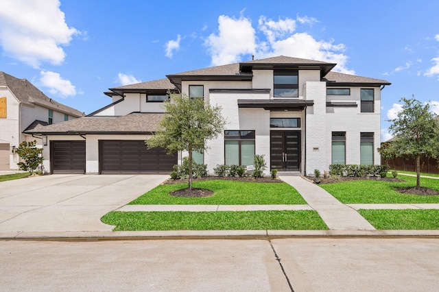 6618 Mirabeau Ln, Katy, TX 77493 - view of front facade with driveway, a front lawn, an attached garage, and brick siding
