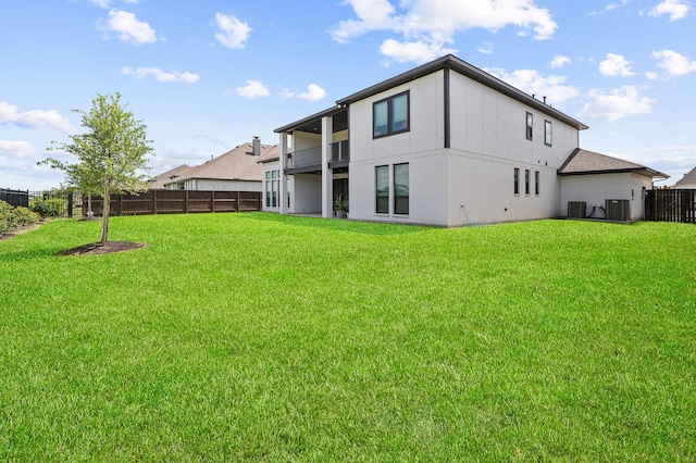 6618 Mirabeau Ln, Katy, TX 77493 - rear view of house with a fenced backyard, brick siding, and a balcony