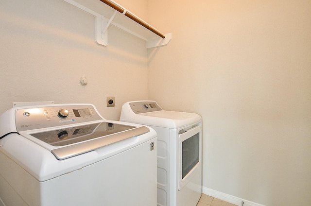 24938 Pavarotti Pl, Katy, TX 77493 - laundry room with washer and clothes dryer and light tile patterned flooring