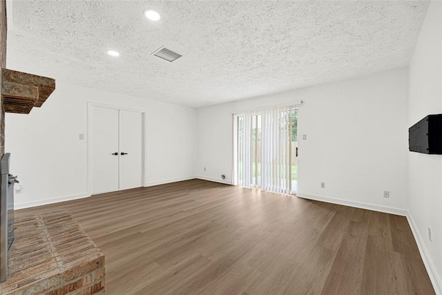711 Charidges Dr, Houston, TX 77034 - unfurnished living room with a textured ceiling, wood finished floors, and recessed lighting